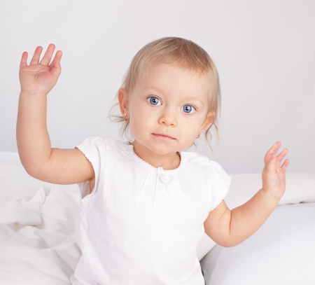 Beautiful baby in bedの写真素材