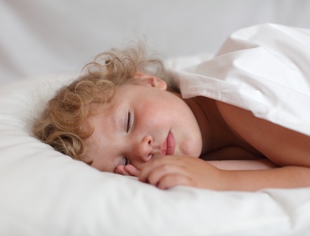 Baby sleeping in the bedの写真素材