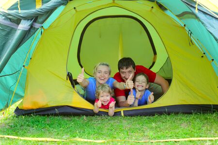 Happy family with two children in tentの写真素材