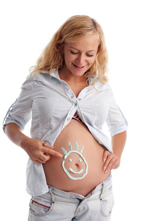 Pregnant woman with a smilie on a stomachの写真素材