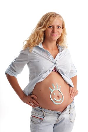 Pregnant woman with a smilie on a stomachの写真素材