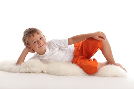 Happy child laying on a floorの写真素材