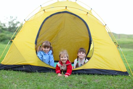 Three happy girls in tentの写真素材