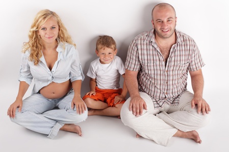 Father, son and pregnant mother. Isolated on whiteの写真素材