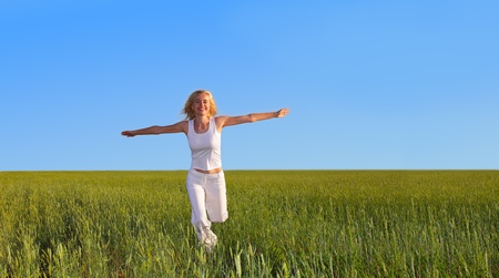 Woman running on a meadowの写真素材