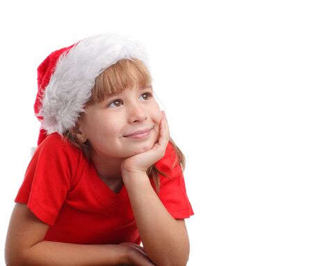 Girl in a Christmas hat thinking isolated on whiteの写真素材