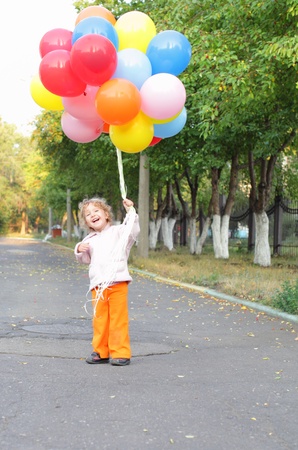 Little girl with set of balloonsの写真素材