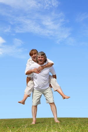 Happy mature pair against the skyの写真素材
