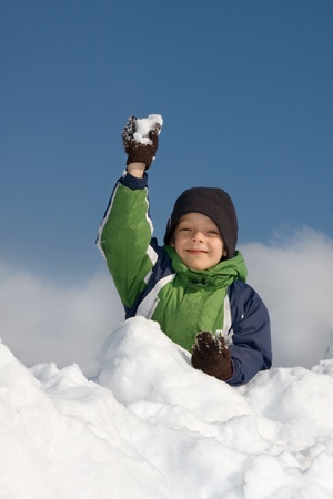 Happiness boy playing snowballsの写真素材