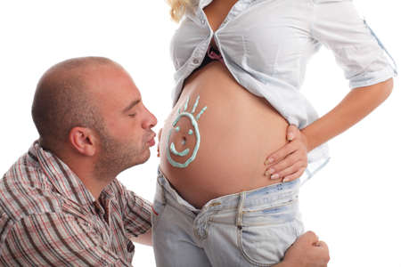 Man a kissing stomach of the pregnant wife. Isplated on whiteの写真素材