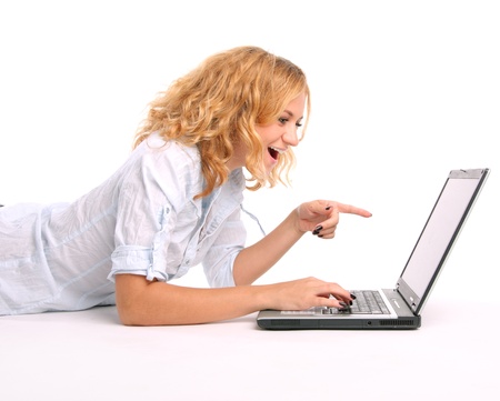 Surprised woman looks in the laptopの写真素材