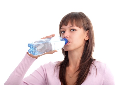 Young woman drinks pure water from a bottle の写真素材