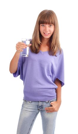 Young woman holds a glass of pure waterの写真素材