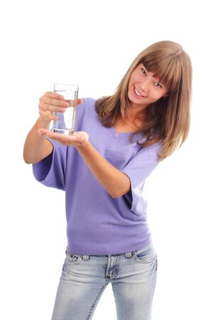 Young woman holds a glass of pure waterの写真素材