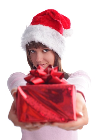 Young woman in a Christmas cap with a gift isolated on whiteの写真素材