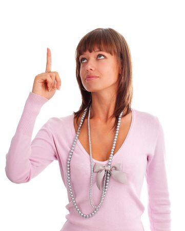 Happy young woman shows an index finger upwardsの写真素材