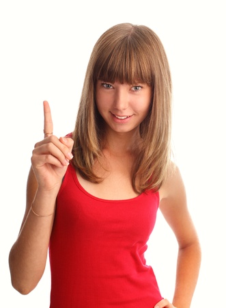 Happy young woman shows an index finger upwardsの写真素材
