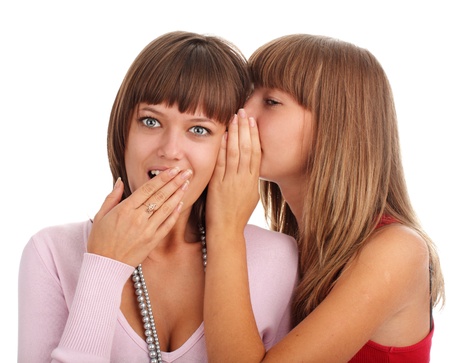 Woman whispers to the girlfriend secretsの写真素材