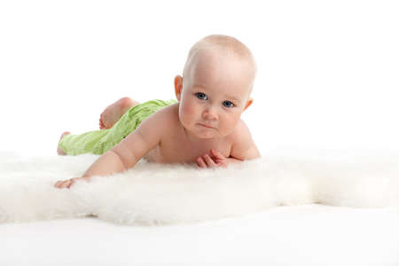 beautiful baby on a soft rugの写真素材