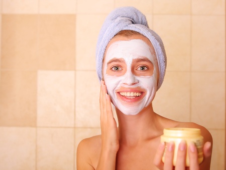 Beautiful woman puts on the face a maskの写真素材