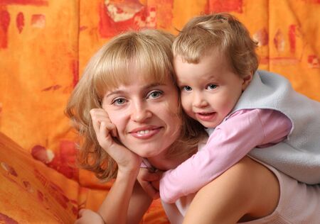 Cheerful mum plays with a daughter 4の写真素材