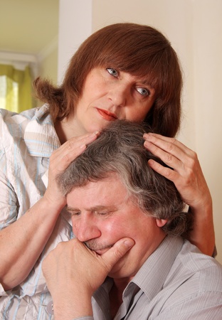 Sad senior couple at homeの写真素材