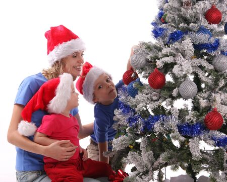 Happy mother and children over christmas treeの写真素材