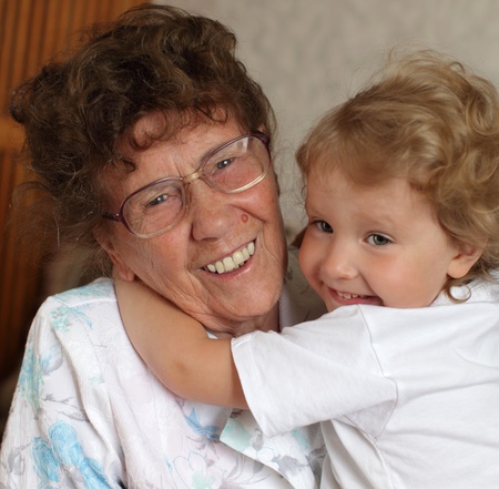 Happy prograndmother with the granddaughter at homeの写真素材