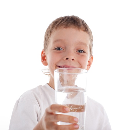 Child with water in glass isolated on whiteの写真素材