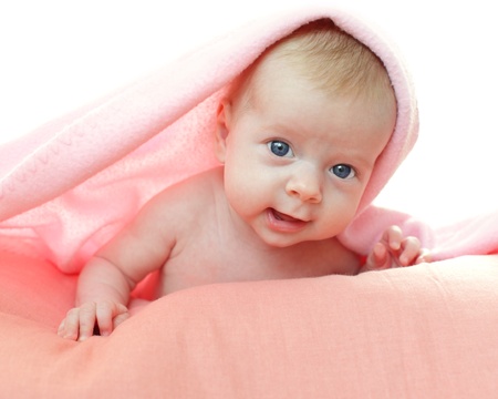 Beautiful baby under pink blanketの写真素材