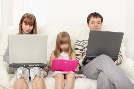 Happy family with laptop at roomの写真素材