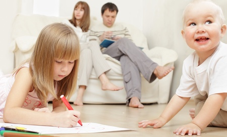 Happy family with two children at homeの写真素材