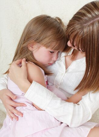 Mother calms the sad daughter の写真素材