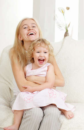 Happy mother with a daughter at homeの写真素材
