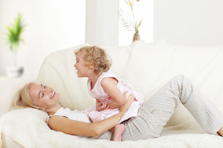 Happy mother with a daughter at homeの写真素材