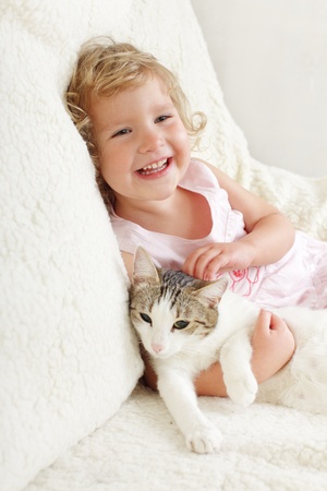 Little happy girl with a catの写真素材