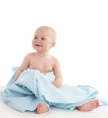 Baby under towel isolated on whiteの写真素材