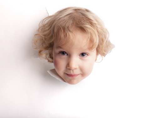 Little girl looking out of a holeの写真素材