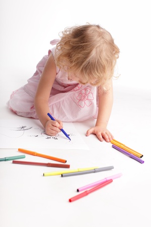 Little girl drawing isolated on whiteの写真素材