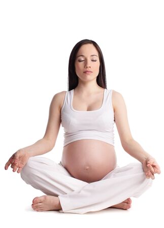 Meditating pregnant woman isolated on whiteの写真素材