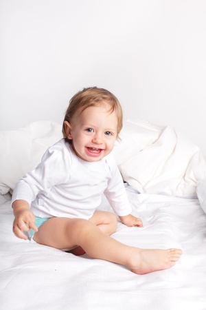 Baby laying on a bedの写真素材