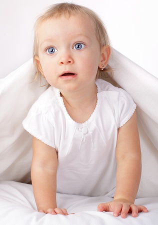 Beautiful baby in bedの写真素材