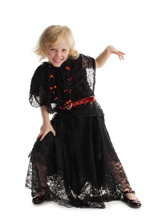 Little girl in costume of a witch isolated on whiteの写真素材
