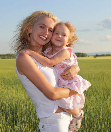 Happy mother with daughter outdoorsの写真素材