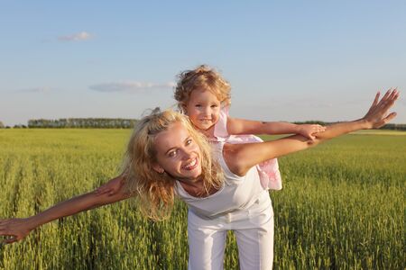 Happy mother with daughter outdoorsの写真素材