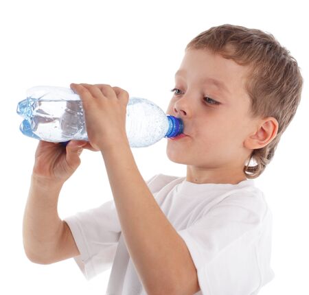 Boy with a water bottle isolated on whiteの写真素材