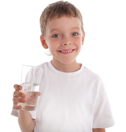 Child with water in glass isolated on whiteの写真素材