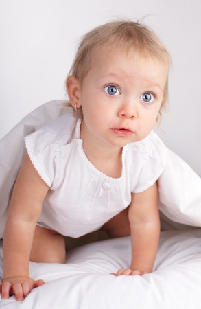 Beautiful baby in bedの写真素材