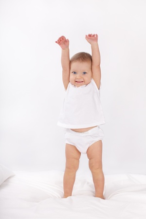 Beautiful baby in bedの写真素材