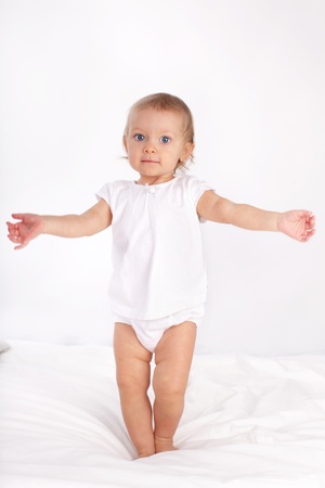 Beautiful baby in bedの写真素材